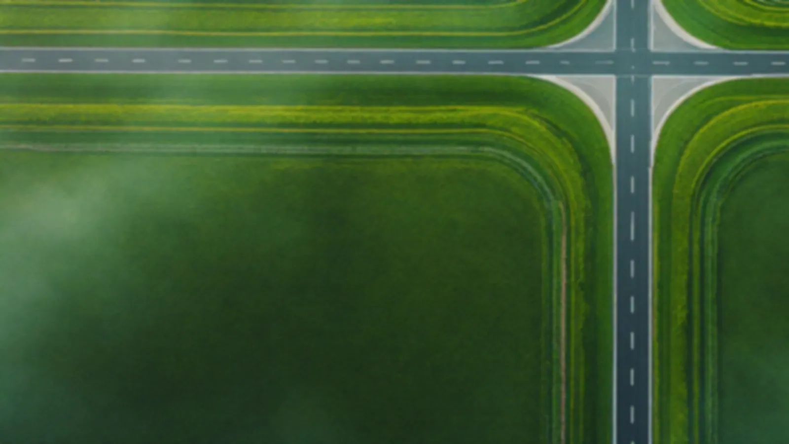 Aerial view of an empty crossroads in green farmland under soft morning fog, the GearboxQuote view of compare loan offers online, $100 – $5,000